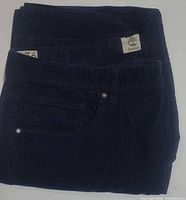Folded navy corduroy Timberland pants front pocket visible