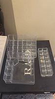 All three clear acrylic makeup organizers on tabletop