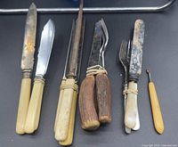 Full group of assorted flatware pieces with varied handles