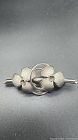 Front view of sterling silver floral brooch
