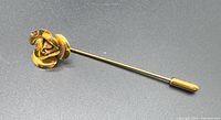 Full view of stick pin with rose head and end cap
