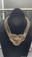 Full view of multi-strand mesh knot collar necklace on bust