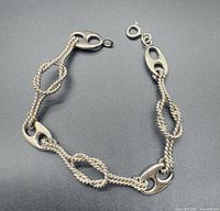 Full bracelet laid flat showing link pattern and clasp