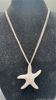 Full view of starfish pendant necklace on display bust