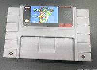 Front view of Super Mario World SNES cartridge showing label and overall condition