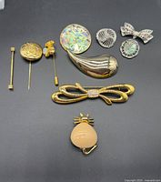 All nine jewelry pieces arranged on black background