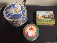 Overview of all three tins arranged on table