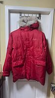 Front view of red Sean John parka with fur-trimmed hood