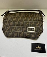 Front view of Fendi Zucca Baguette bag showing FF monogram, buckle, strap