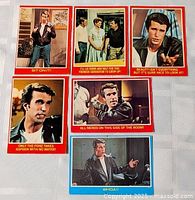 Six Happy Days trading cards laid out on table