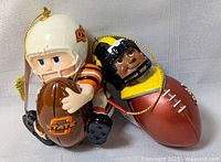 Both college football ornaments side by side