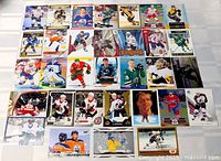 Overhead view of all 32 hockey cards arranged in four-row grid