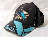 Left front view of black Reebok San Jose Sharks fitted hat