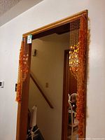 Full view of amber bead curtain installed in doorway