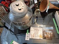 Fryer assembled with lid on glass bowl plus manuals visible