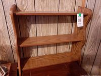 Front view showing three shelf levels and punch-work side design