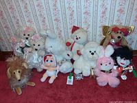 Group shot of all twelve plush toys lined up against wallpapered wall