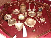 Overall lot showing all brass items in glass case