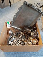 Box contents showing trays, tea service pieces, flatware and goblets