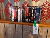 Full row of 14 VHS tapes on shelf