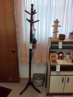 Full view of coat rack with umbrellas attached