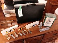 Overall lot showing briefcase, cologne sets, wristwatches, pen and shaving kit