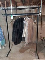 Front view of garment rack with suit and coat hanging