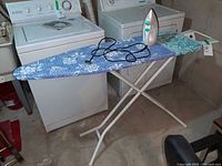 Full view of Leifheit ironing board unfolded with Black+Decker steam iron on top