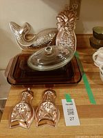 Overall lot showing casserole with lid and four copper molds