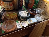 Overall view of nine assorted ashtrays on tabletop