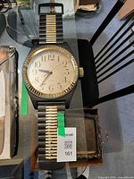 Full view of Marco Polo wristwatch wall clock on table