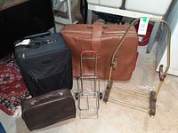 All items grouped: black suitcase, brown suitcase, brown carry-on bag, metal cart, brass luggage stand