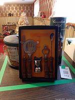 Group shot of boxed bar tool set, ice bucket and Canadian Club tin