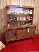 Full view of hutch showing upper glass cabinet, lower buffet, tapered legs