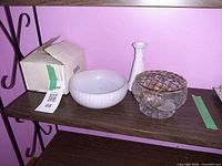 All three pieces on shelf: milk glass bowl, milk glass vase, crystal rose bowl with frog