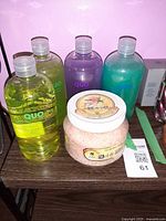 Front view of four Quo bottles and Sel de Mer salt jar on shelf