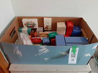 Full view of cardboard box with multiple sealed Avon product boxes