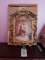 Front view of ornate gold-tone framed print with cardboard backing