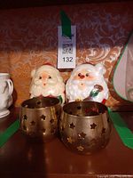 Full lot showing two Santa candles and two brass star cutout holders