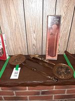 Overall lot showing match holder box and both bed warmers