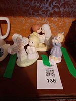 All three Precious Moments figurines on shelf