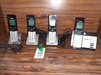 Four handsets on cradles with base station and cords