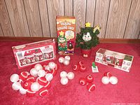 Group shot of tree toy, two boxed mug sets, and loose ornaments