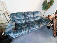 Front view of three-seat multicolor reclining sofa