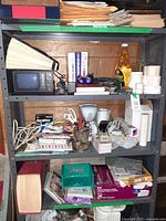 Full view of shelving unit with assorted office supplies