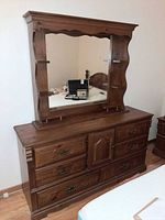 Front view of wood dresser with attached mirror