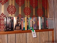 Full row of 27 VHS tapes on shelf
