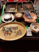 Overview showing trays, bamboo platter, shell dish, spoons, coasters, plate and glasses