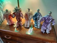 Group of five Pierrot dolls on dresser