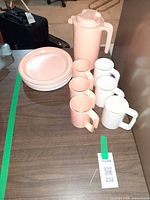 Group view showing pitcher, mugs, plates